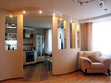 Неплохим вариантом разграничения пространства считается частичный разбор стены между кухней и гостиной — фрагмент конструкции можно использовать в качестве барной стойки или для декоративного оформления